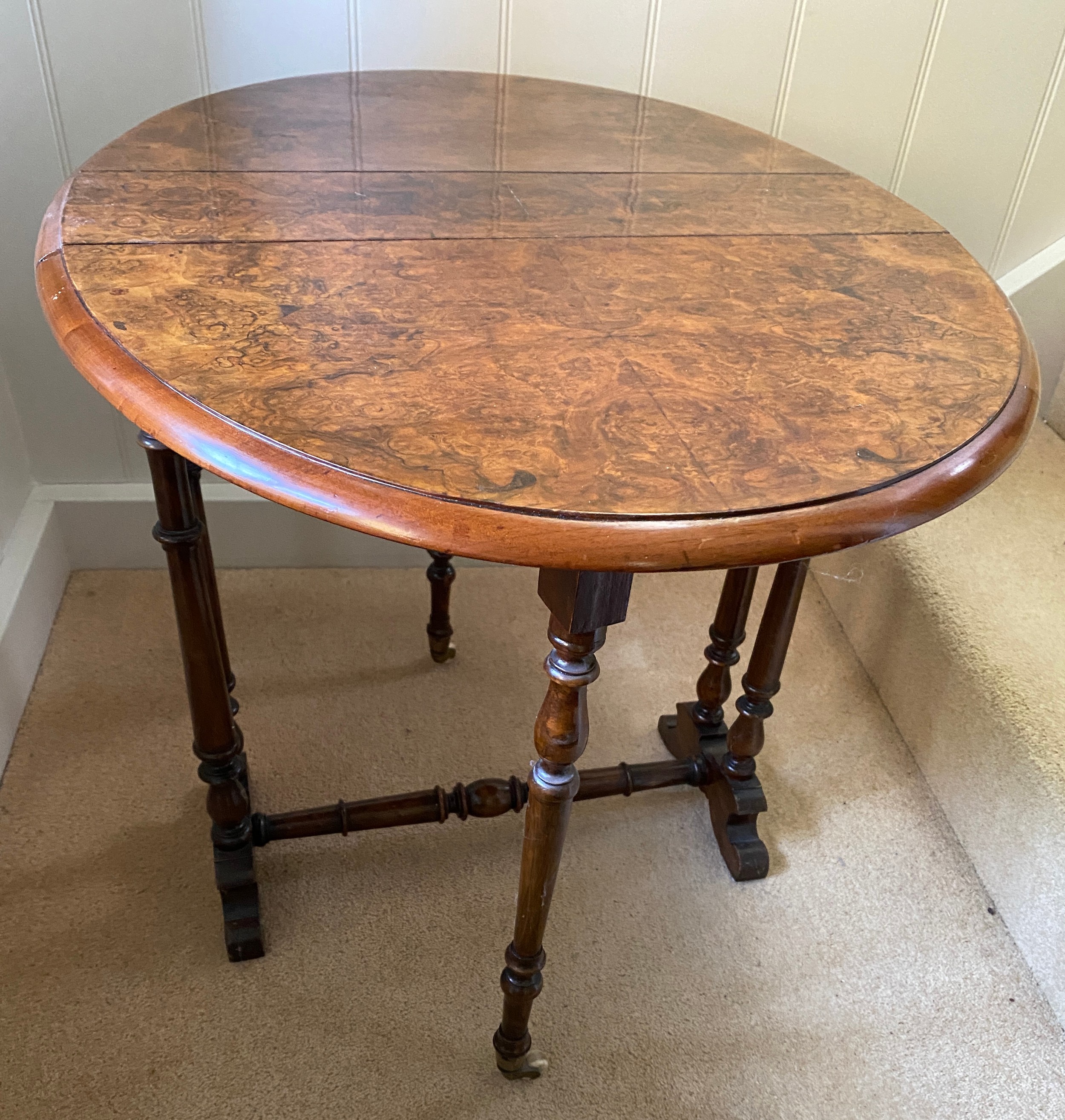 A 19thC burr walnut oval drop leaf table on white porcelain castors. Open 70 x 53 x 53cm h. Closed - Image 4 of 4