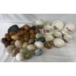 A mixture of wooden and marble eggs along with a rock fossil and a set of Biltons England ceramic