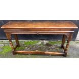 A good quality 20thC oak side table with carved frieze, turned legs and stretchers to front and