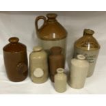 Collection of stoneware receptacles to include large flagon 35cm h, smaller flagon 26cm h with J H