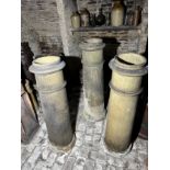 Three Long John terracotta chimney pots two stamped 'James Goody, Darfield Works, Barnsley', 124cm h