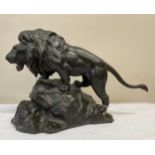 An oriental patinated bronze lion 28cm h, oriental mark to under belly of lion.