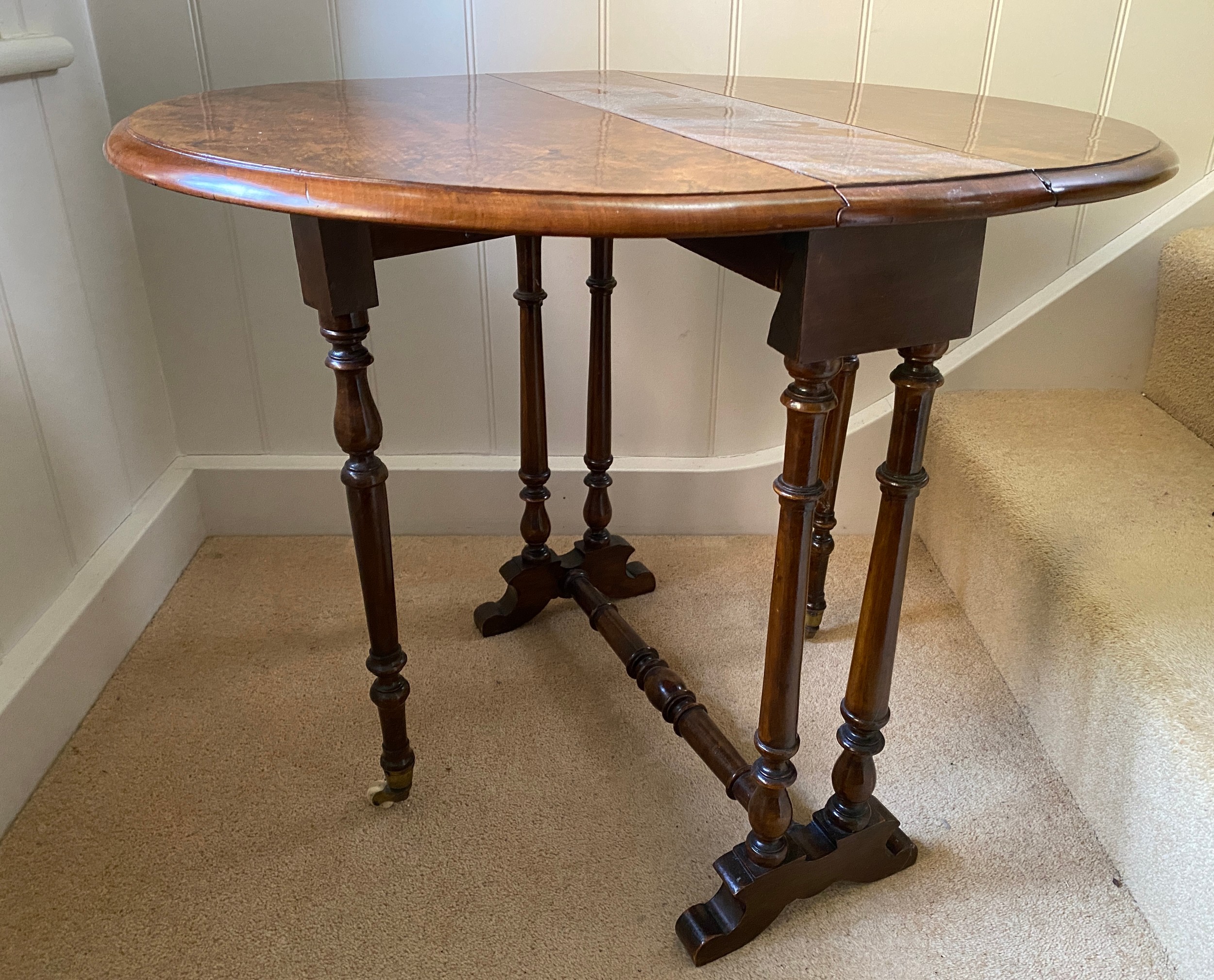 A 19thC burr walnut oval drop leaf table on white porcelain castors. Open 70 x 53 x 53cm h. Closed - Image 2 of 4