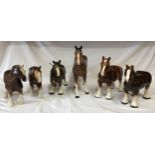 A collection of ceramic horses - five shire horses and one Melba race horse.