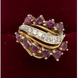 A 14 carat yellow gold ring set with pink and white gem stones. Size K. Weight 5.7gm.