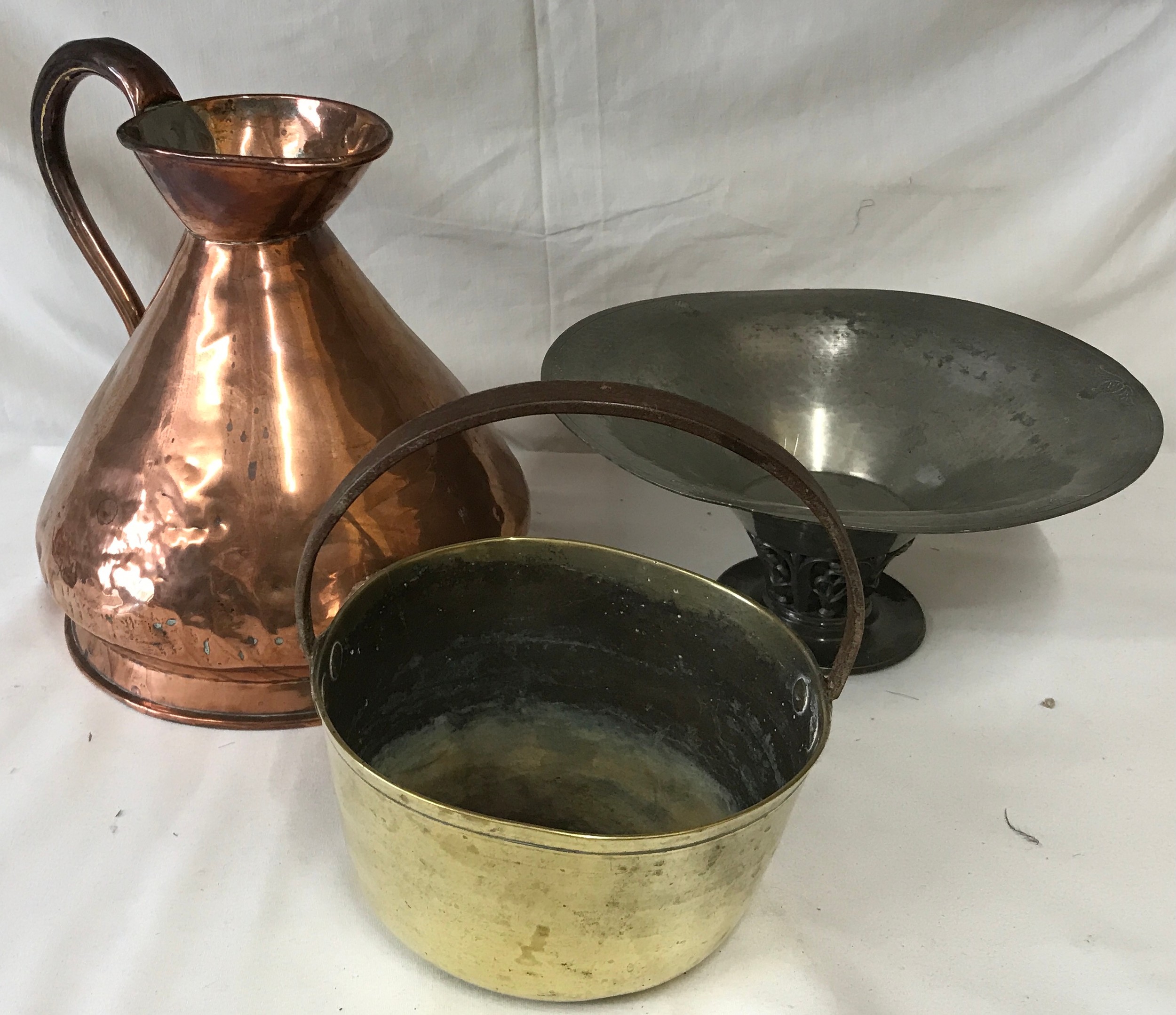 A collection of copper and pewter items to include a large copper jug and bucket with pewter bowl