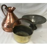 A collection of copper and pewter items to include a large copper jug and bucket with pewter bowl