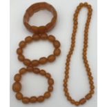 Four amber coloured pieces of jewellery to include a bead necklace 45cm l, two bead bracelets and