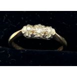 A three stone diamond ring set in 9 carat gold and platinum. Size J. Weight 1.4gm.