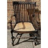 A cane seated oak barley twist armchair.