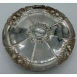 A silver circular dish embossed with fruit. London 1876 maker John Septimus Beresford. 23cm d.