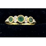 Eighteen carat gold ring set with emeralds and diamonds. Size Q. Weight 2g.