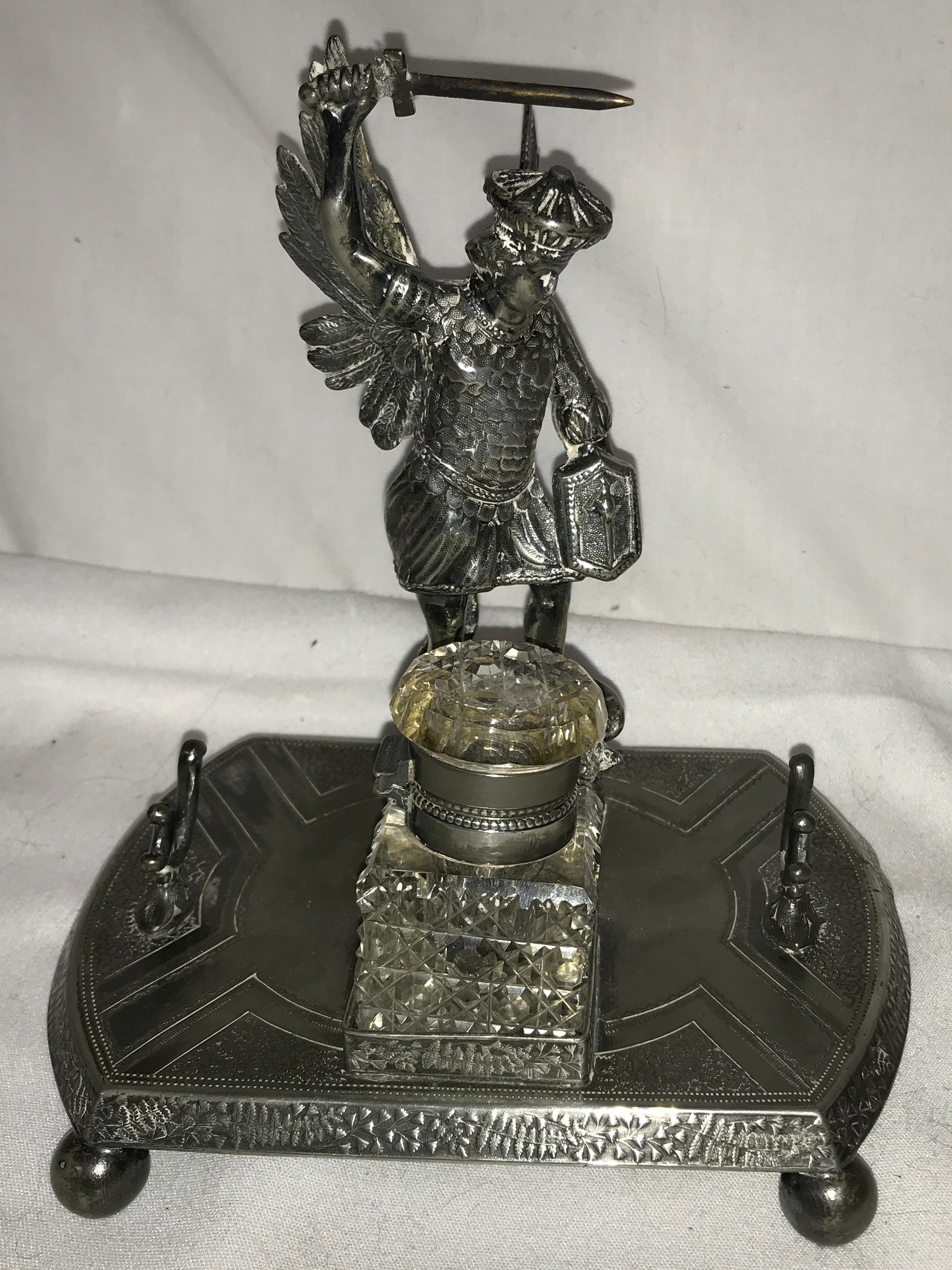 A silver-plated inkstand by James Deakin & Sons (1871-1939), to the centre a cast of St George and