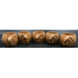 Five Robert 'Mouseman' Thompson carved octagonal oak napkin rings.