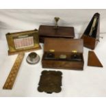 A selection of desk items to include metronome, three perpetual calendars, wooden box with two
