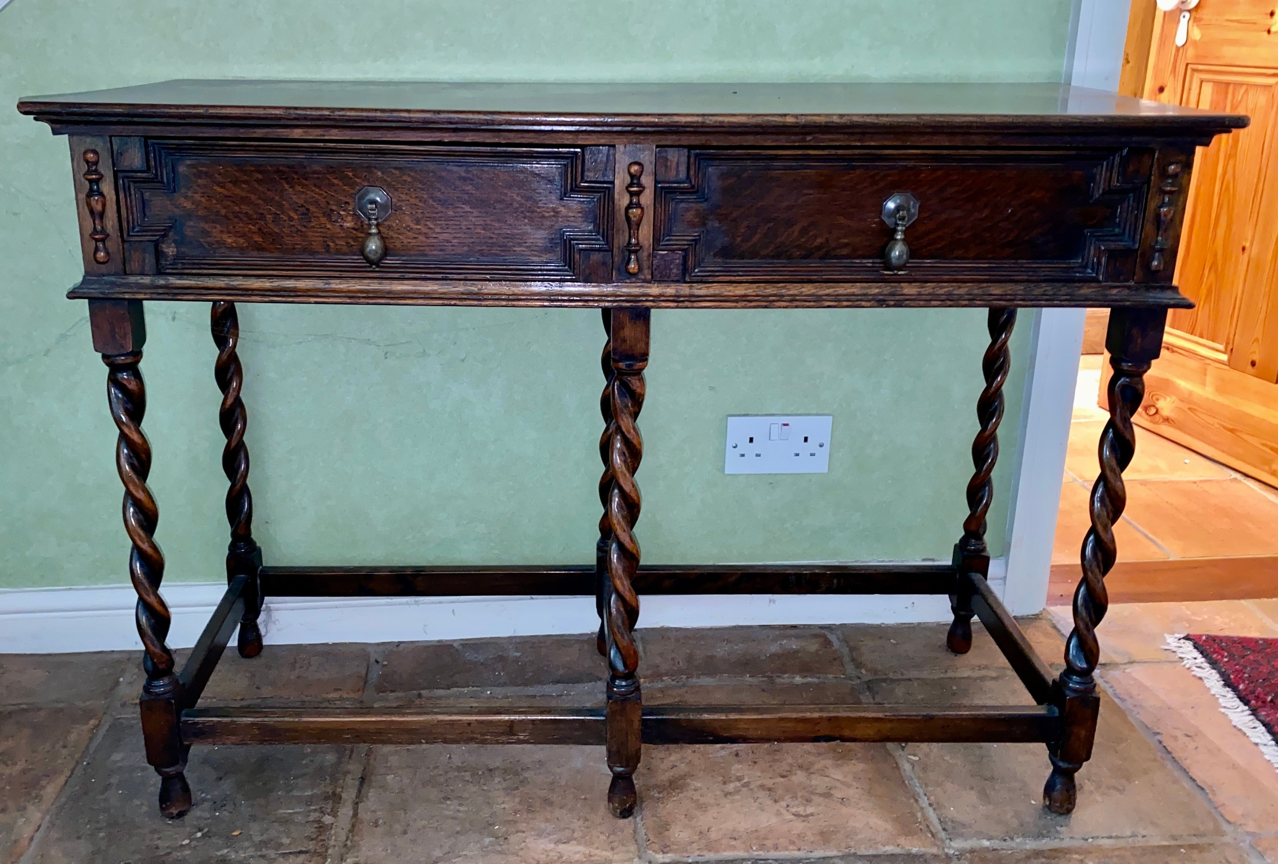 An oak two drawer side table on barley twist legs. 106 w x 77 h x 40cm d.