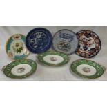 Seven ceramics to include 4 plates and three tazzas. The tazzas are green and white and two have one