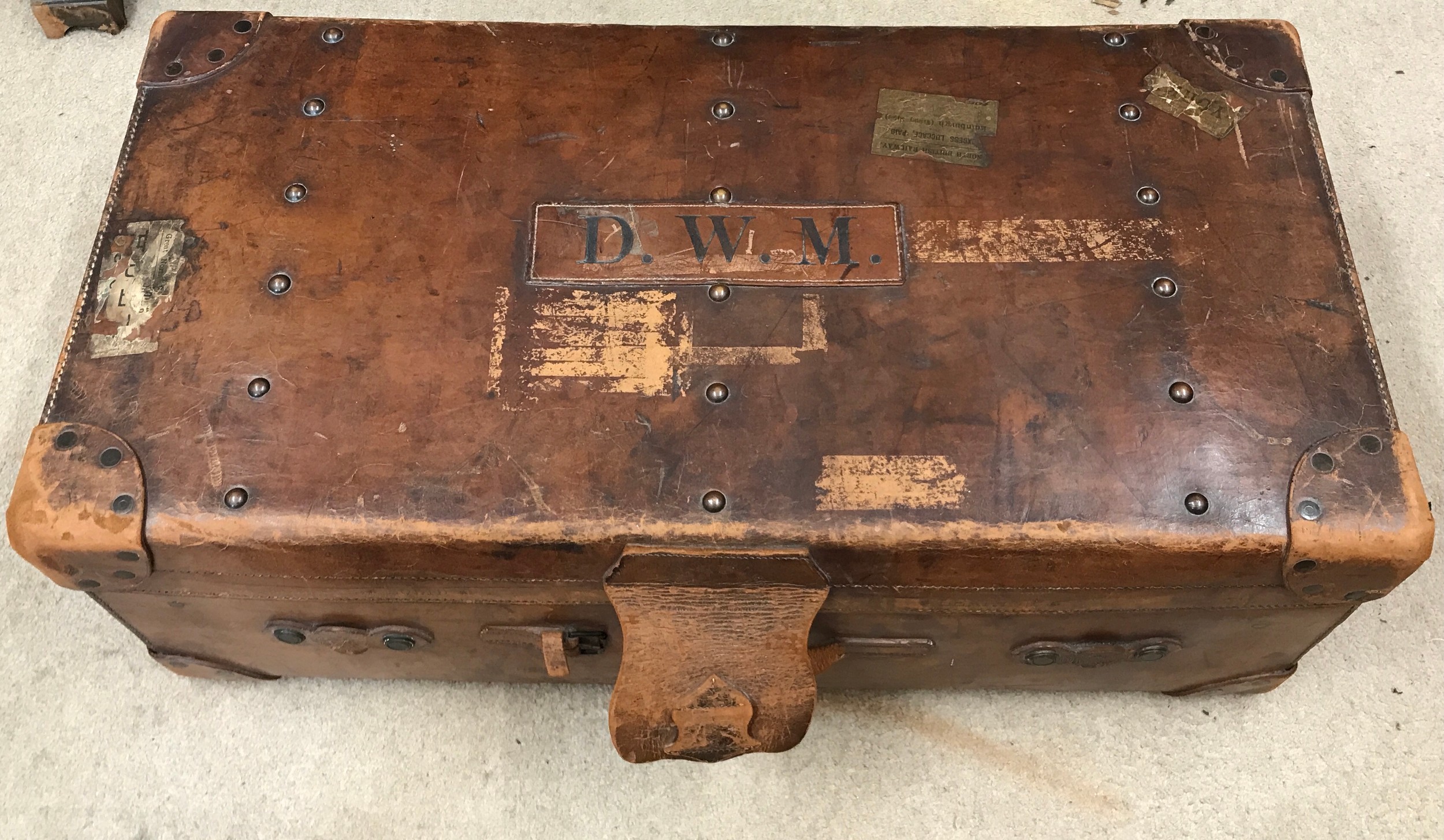 A good quality early 20thC Vintage solid leather travel trunk, stamped John Pound & Co of London.