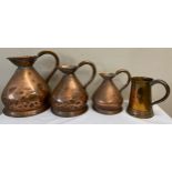 Three graduated copper measures together with a copper tankard. Largest jug 28cm h.