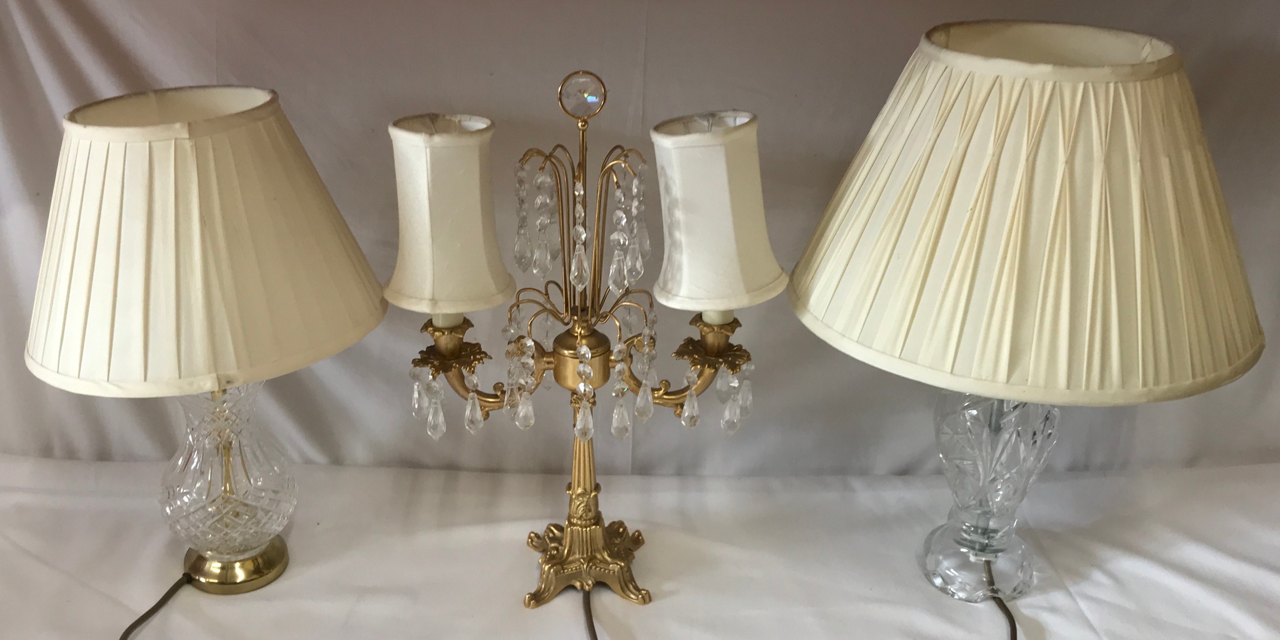 Two cut glass table lamps and one twin branch brass and glass table lamp with lustres 45cm at