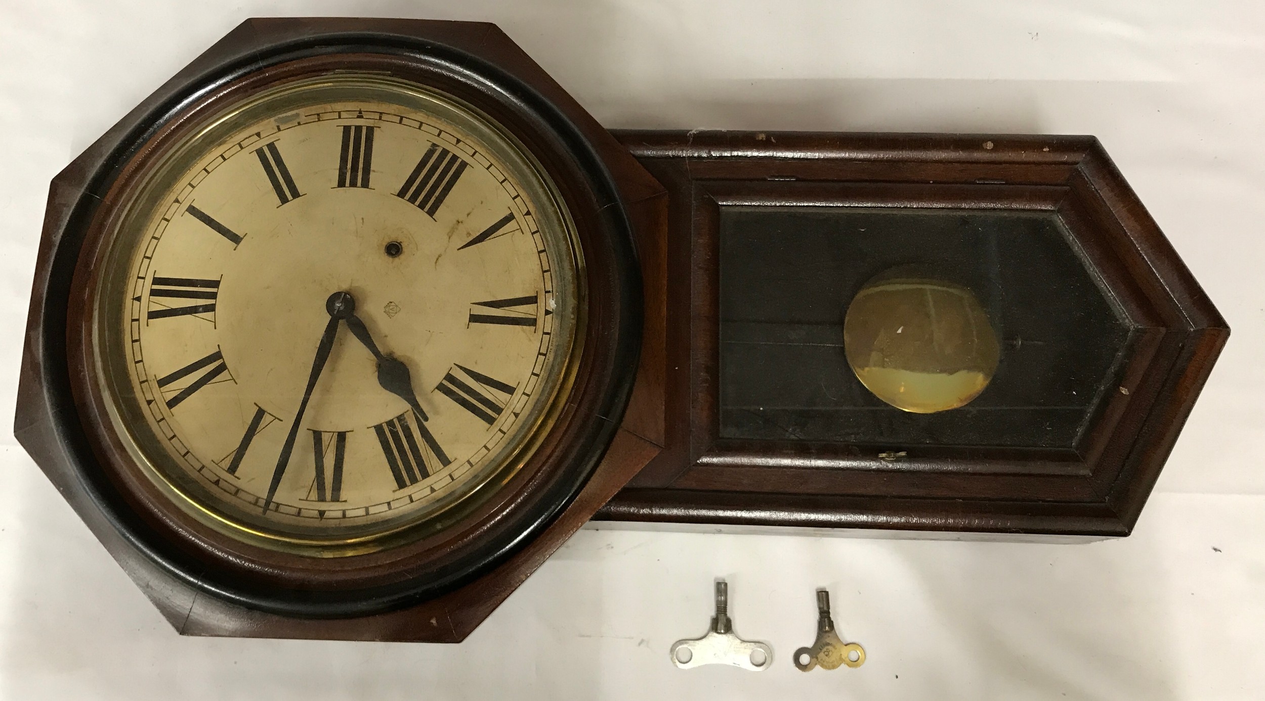 An American regulator cycle 8-day wall clock in octagonal wooden case with metal face using roman