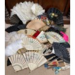 A selection of various fans to include paper, feathers, wood, plastic etc to include a paper fan