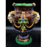 A Minton majolica "Bacchus" vase applied with three satyr masks on a circular base, impressed