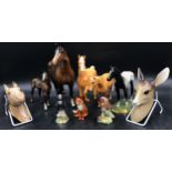 A collection of ceramic animals to include a Royal Doulton black horse, W.R. Midwinter deer faun