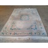 Large Chinese rug on pale ground. 290cm x185cm.