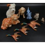 A collection of ceramic animals to include a blue dog and two other dogs, a Just cat and a Royal