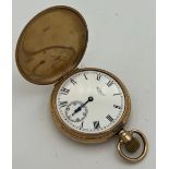 A nine carat gold hunter pocket watch by Waltham. Keyless wind with white enamel dial with Roman