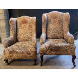 Two upholstered wing back chairs on cabriole legs and castors in need of restoration. Tallest to the