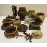 Oriental items to include a pair of brass faceted vases, hard wood stands, a carved wooden lidded