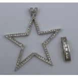 Two 18 carat white gold pendants set with diamonds. Star 4cm diameter. Total weight 7.6gm.