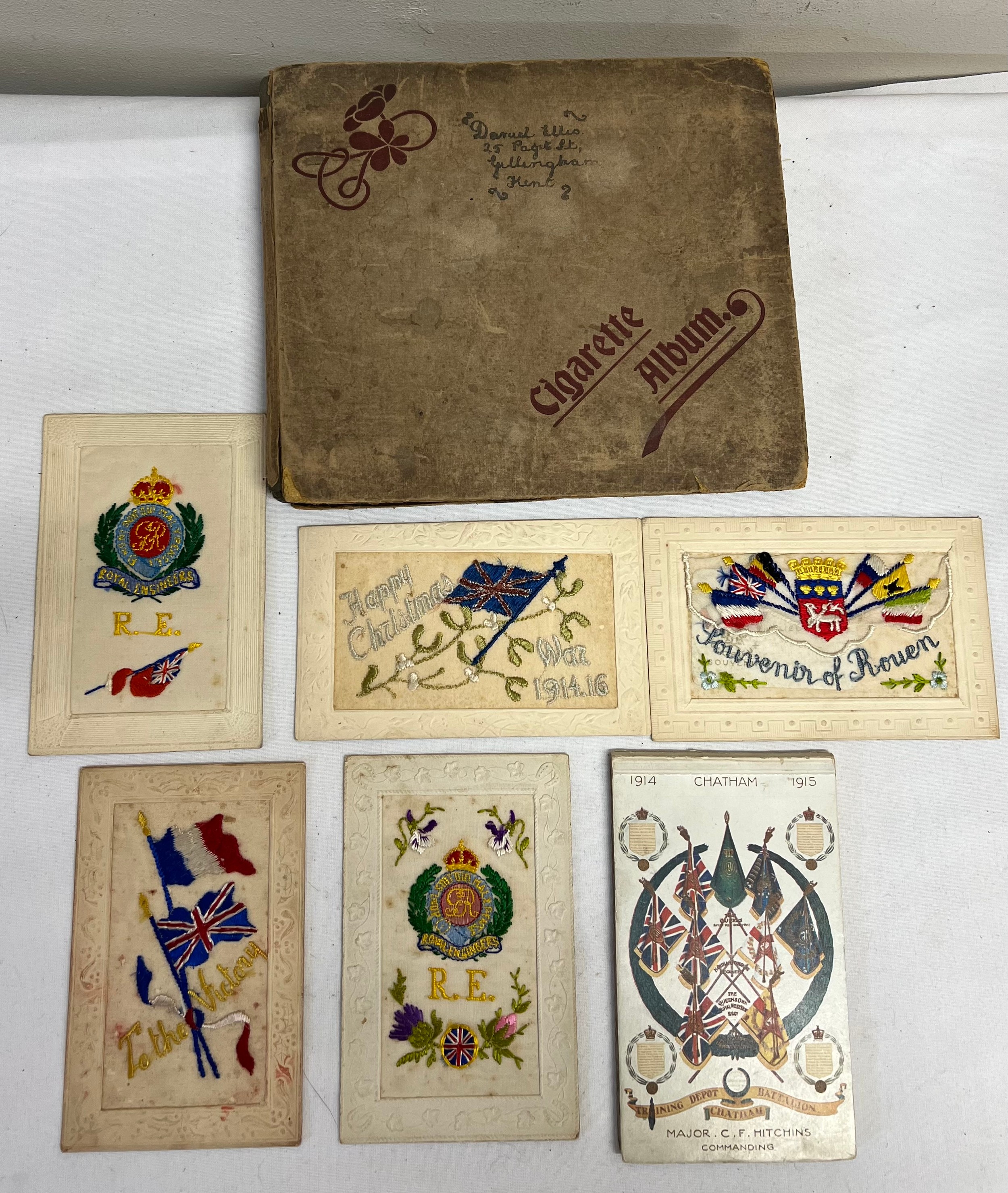 Cigarette album and contents together with five WWI silk postcards and a WWI postcard album.