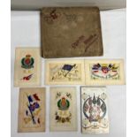Cigarette album and contents together with five WWI silk postcards and a WWI postcard album.