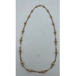 A 9 carat gold chain and bead necklace, weight 9.9gm. Length 58cm.