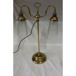 A brass two way desk lamp with opaque and clear glass shades. 56cm h x 33cm w shade to shade.
