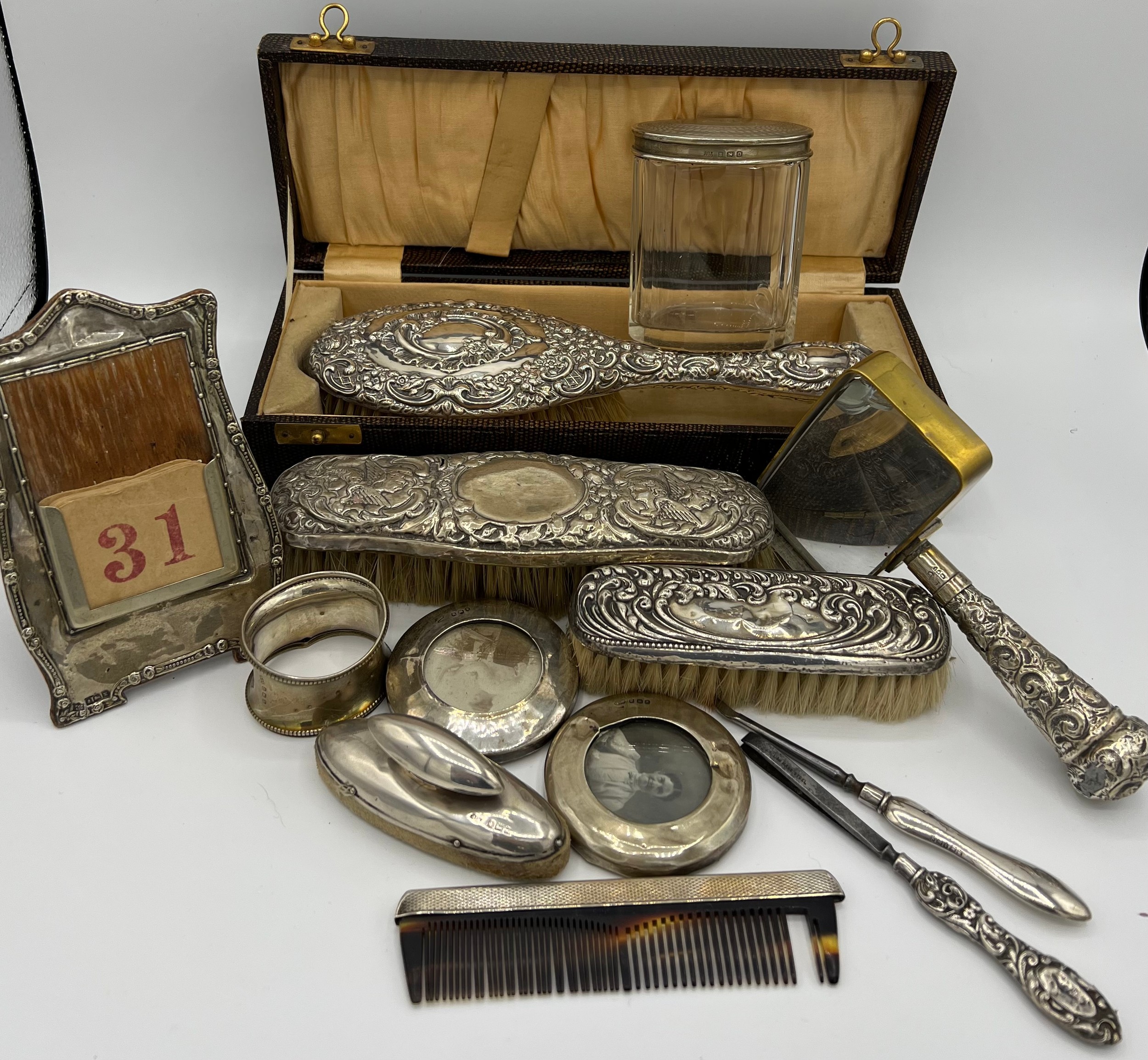 A quantity of silver to include boxed hairbrush, clothes brushes, napkin ring, nail buffer, comb,