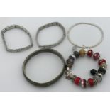 A selection of five bracelets to include two Nomination bracelets, a Pandora bracelet with 3 spare