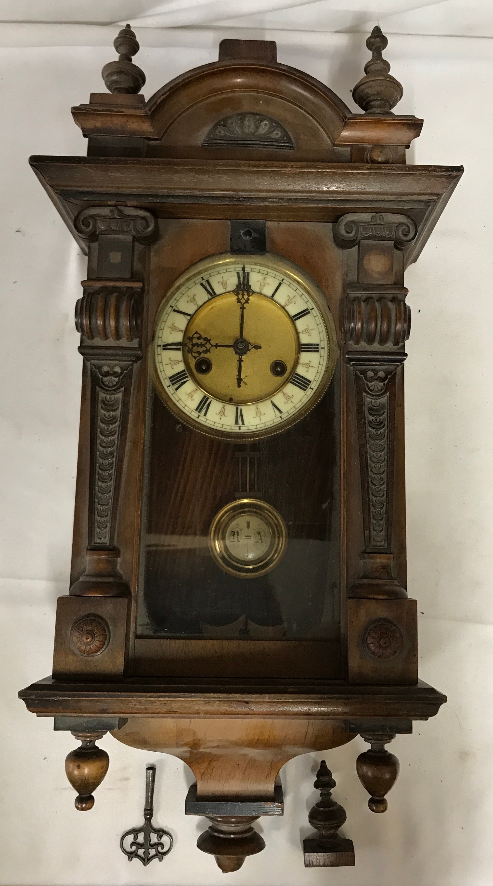 A wall clock with R A marked on pendulum with key. Approx. 60 h x 16 d x 30cm w.