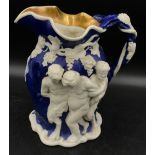 A 19thC Minton Bacchanalian Jug of large proportions, in blue glaze moulded with figures of