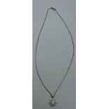 An 18 carat white gold star pendant set with diamonds on fine chain 44cm length. Total weight 3.9gm.