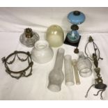 A selection of 19thC lighting, various lamps, shades and funnels to include a vaseline shade.