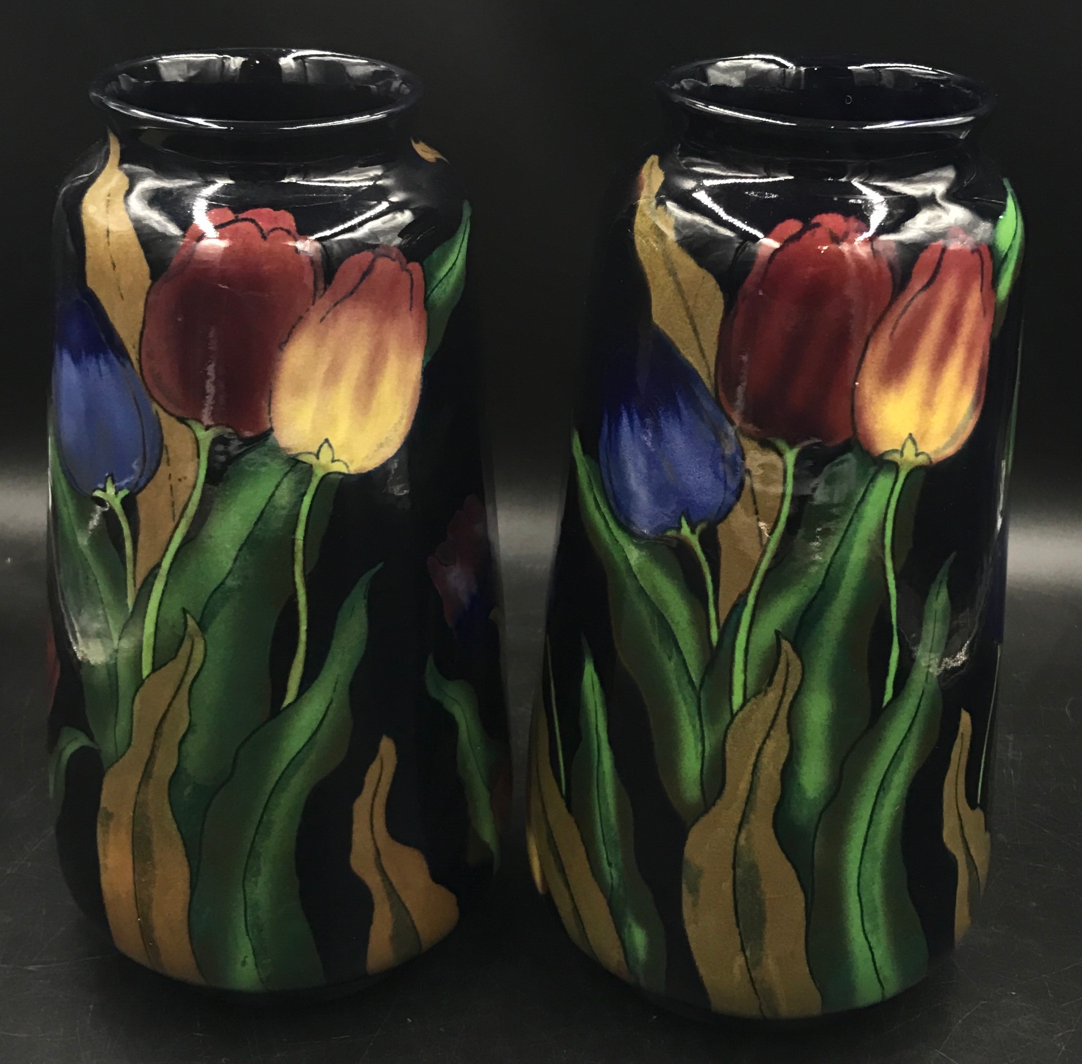 A pair of Royal Stanleyware 'Jacobean' tall vases decorated with tulips on a dark blue ground, 30.