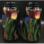 A pair of Royal Stanleyware 'Jacobean' tall vases decorated with tulips on a dark blue ground, 30.