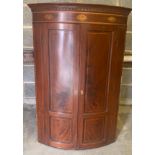 A 19thC mahogany and inlay two door corner cupboard with shelved interior and shell decoration.