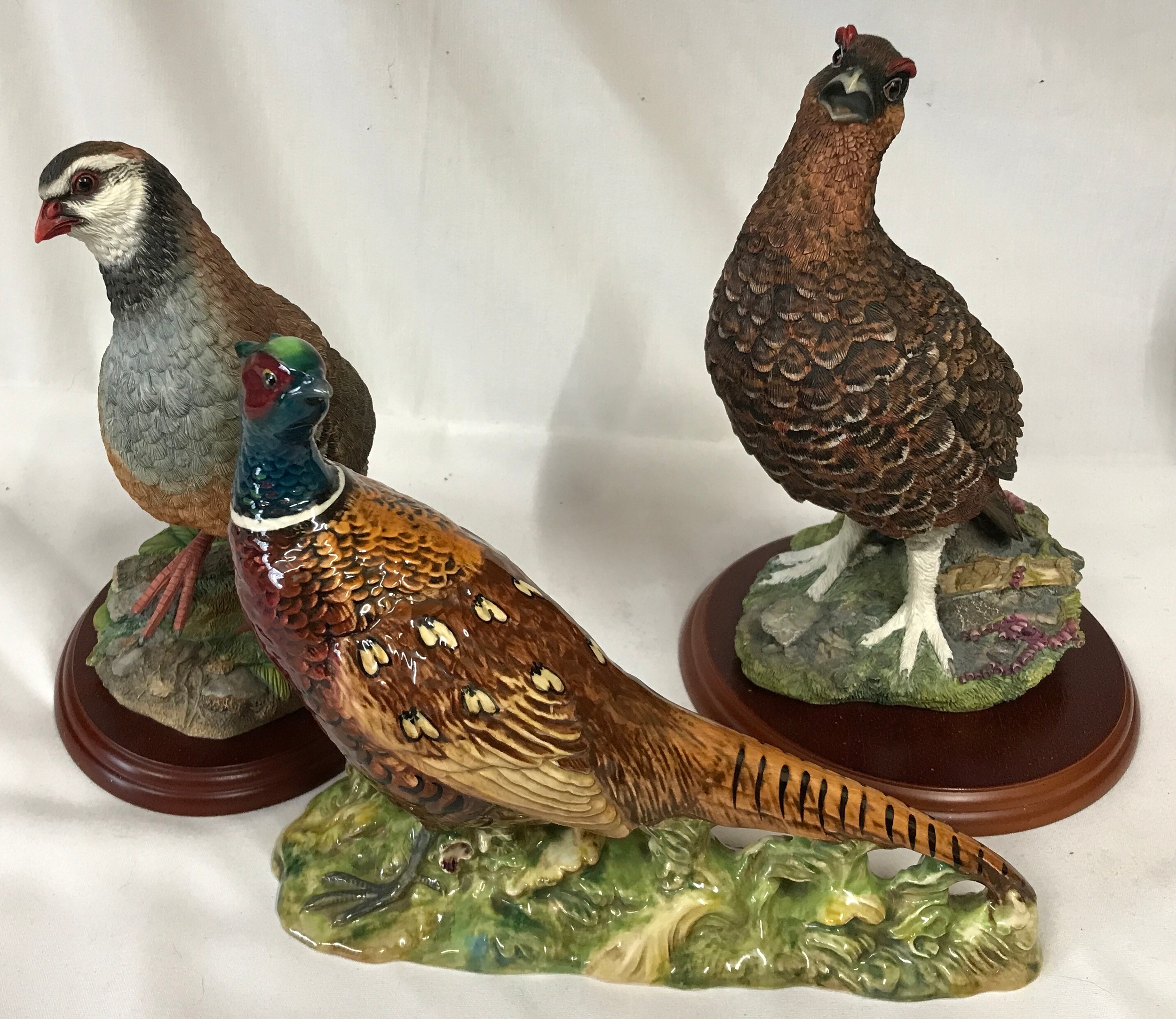 Two Border Fine Arts models Red Grouse A1279, Partridge A0660 along with a Beswick Pheasant 1225.