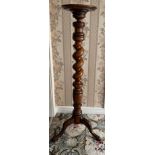 A 19thC mahogany torchere with twisted stem. 113 cm h.