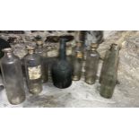 Eight various glass bottles tallest 23cm h.